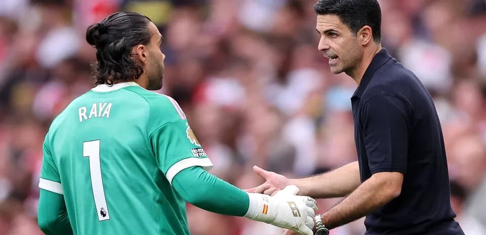 Goalkeeper Raya receiving instructions from coach Arteta