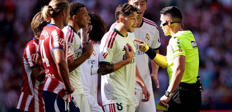 Players arguing with referee during match decision