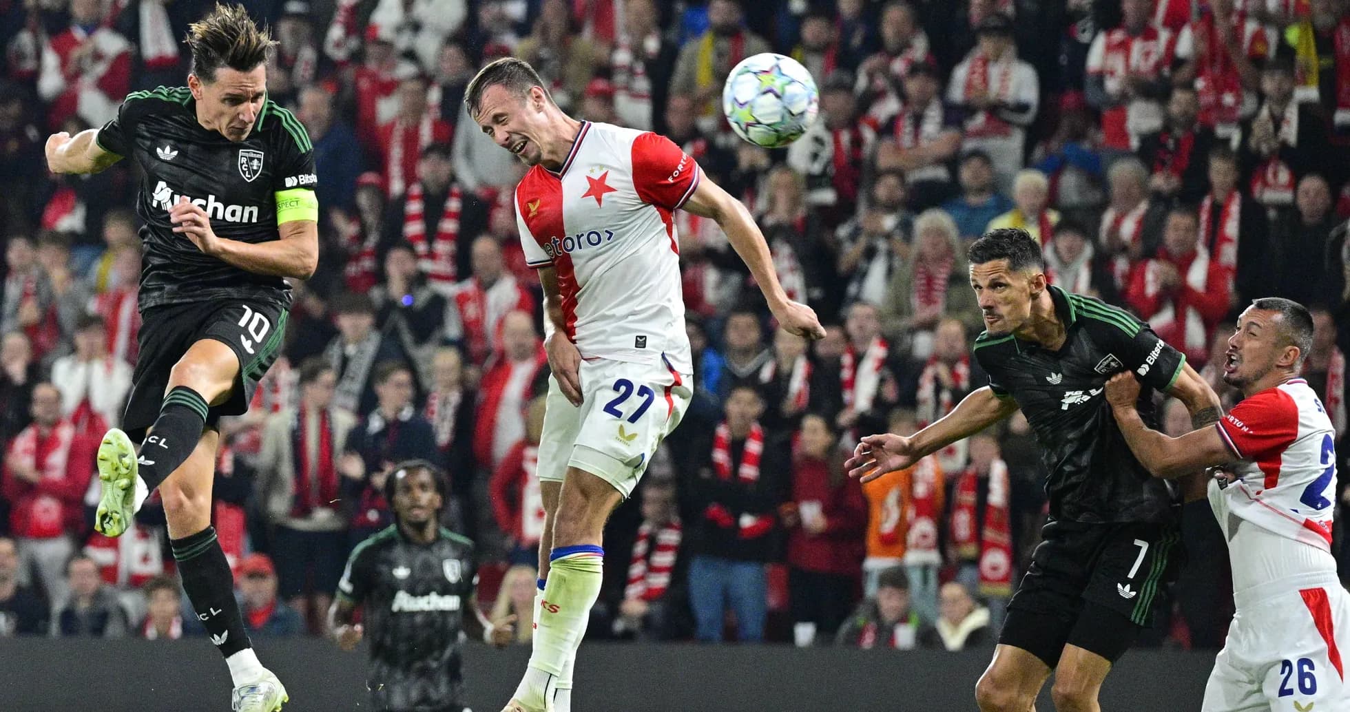Players contesting a header during a football match