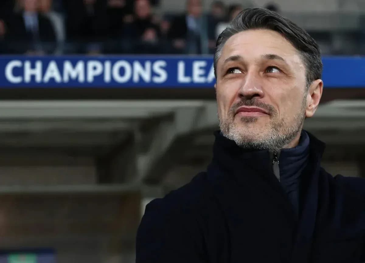 Coach observing match under Champions League banner