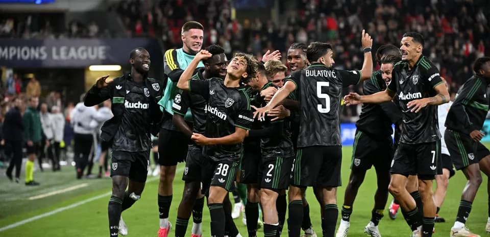 Players celebrating after a goal in Champions League match