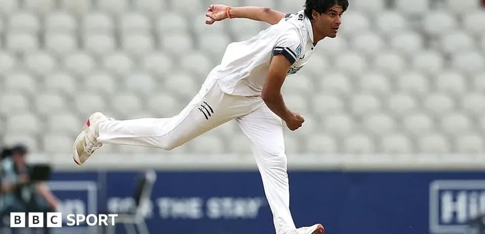 Cricketer bowling during a match at stadium