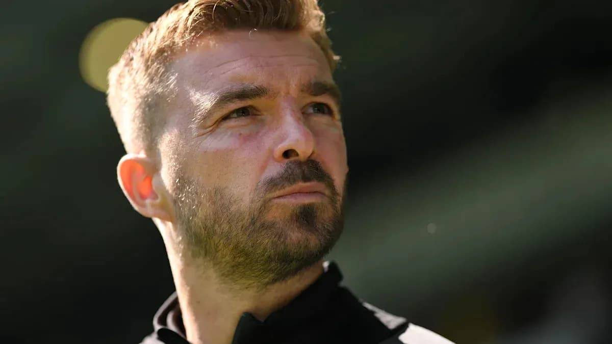 Man with short hair looking thoughtfully into distance