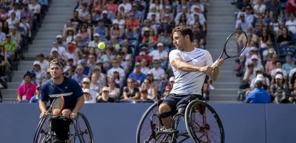 Two wheelchair tennis players competing in match