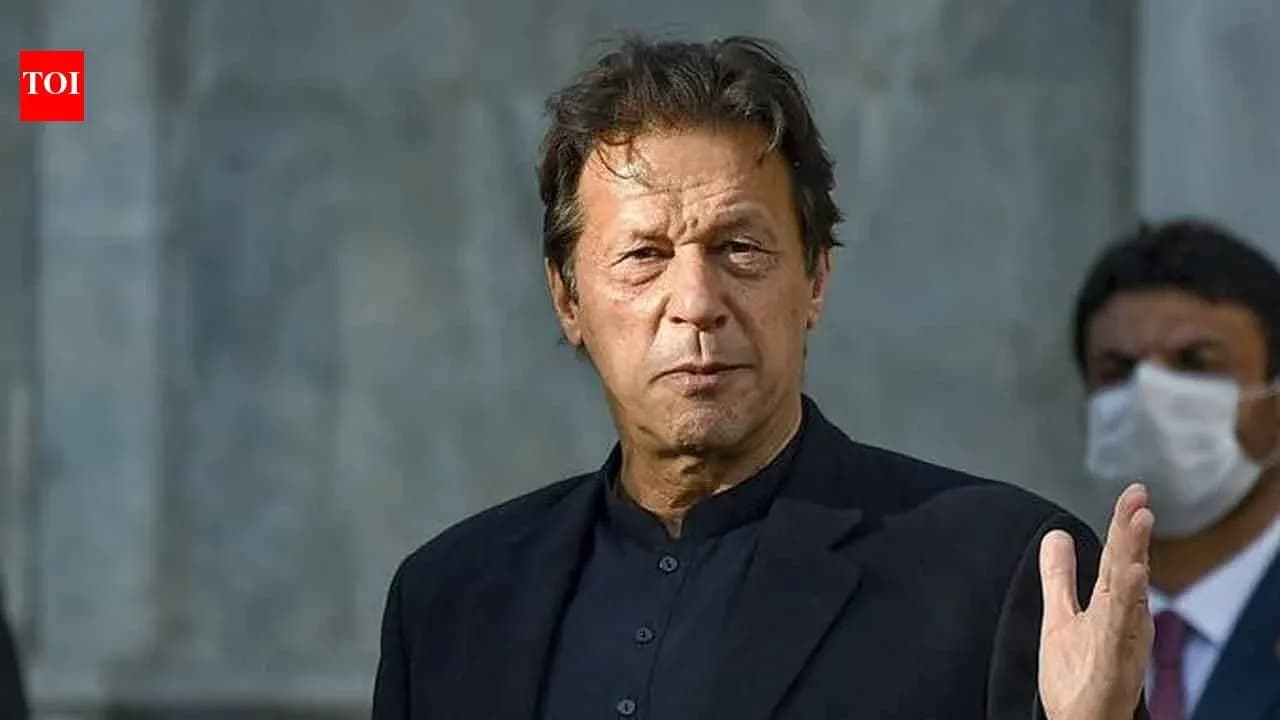 Man in black suit gesturing during a speech