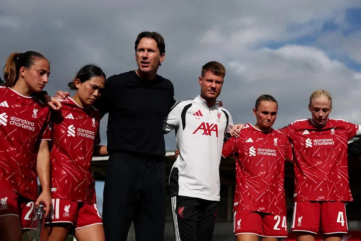 Liverpool women's team in a huddle with coaches