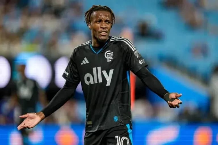 Player gesturing during match in black jersey