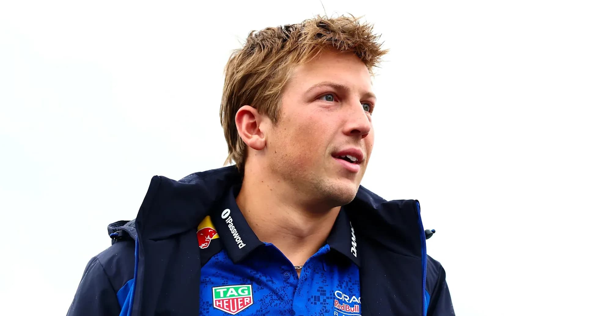 Driver wearing team jacket and shirt outdoors