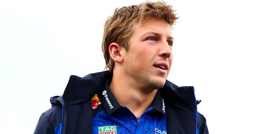 Driver wearing team jacket and shirt outdoors