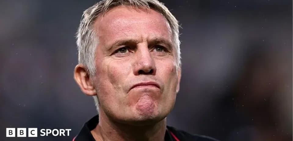 Coach with a serious expression during match