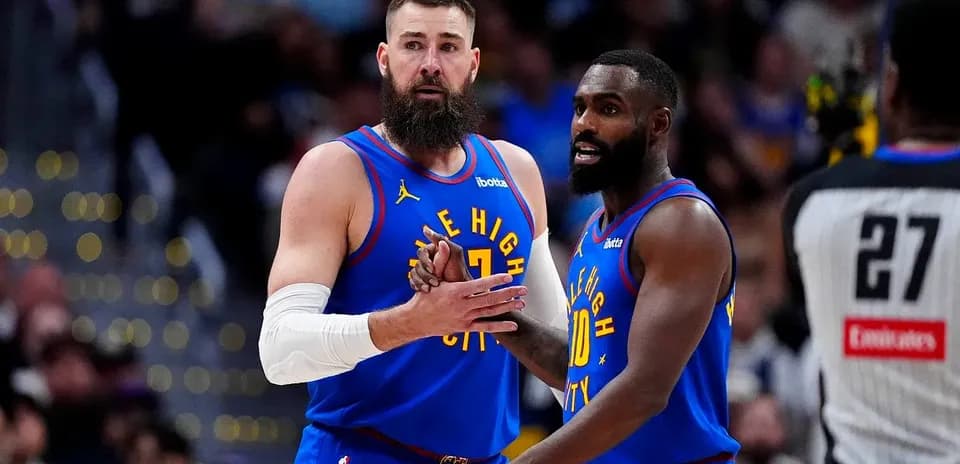 Two players discussing strategy on the court