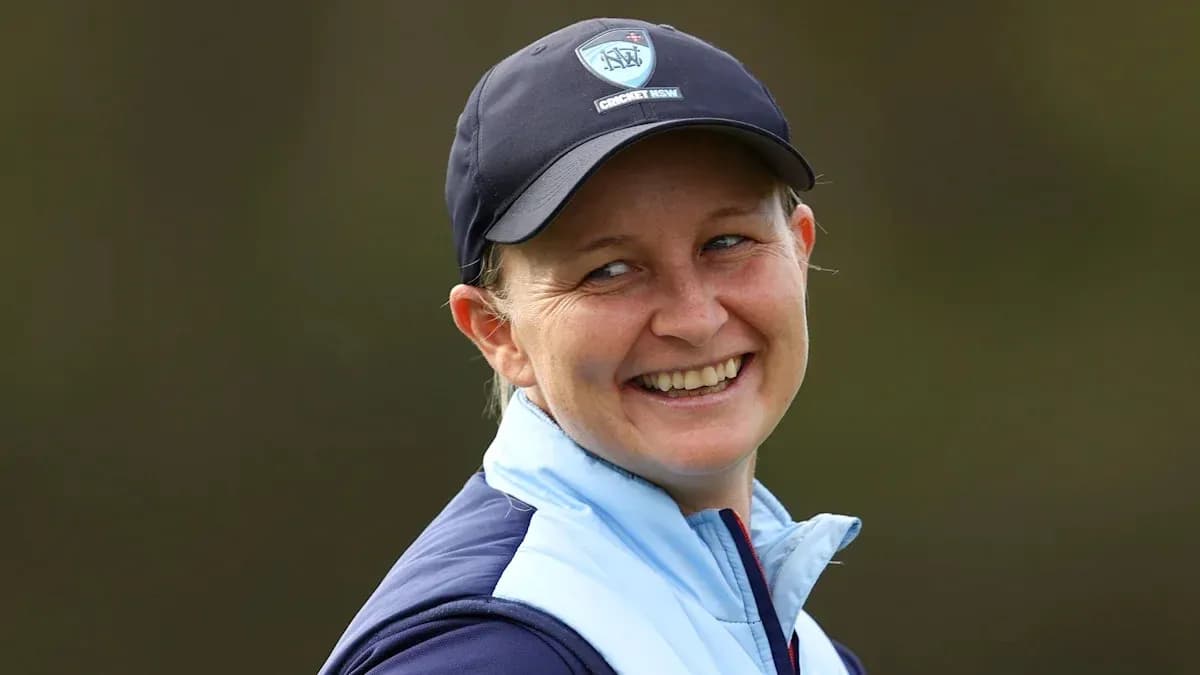 Cricket player smiling during outdoor event