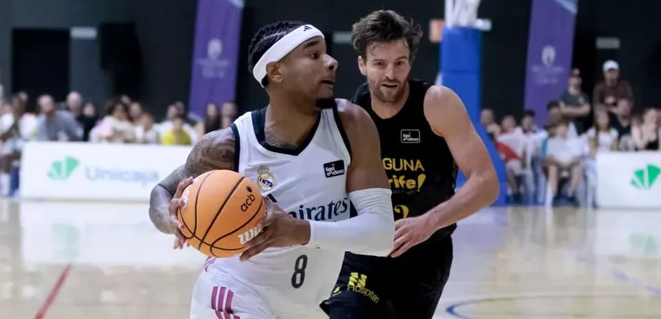 Player dribbling basketball while being chased by opponent