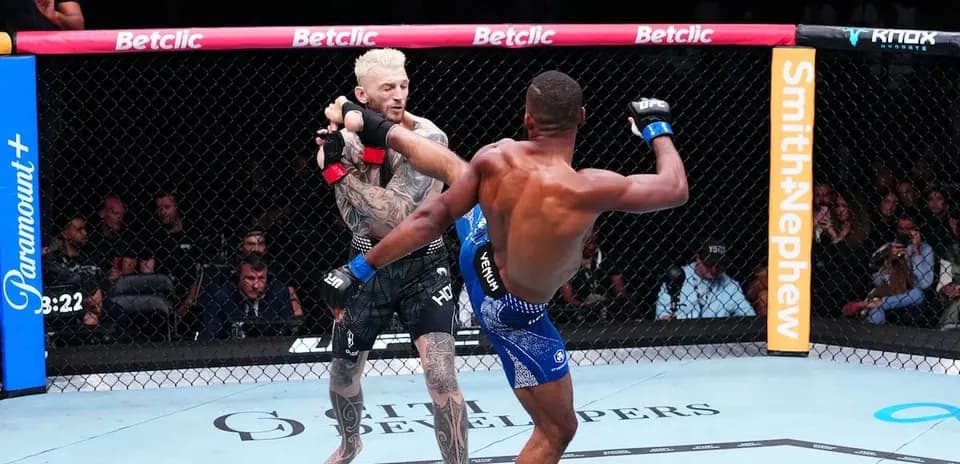 Two fighters engaged in a mixed martial arts match