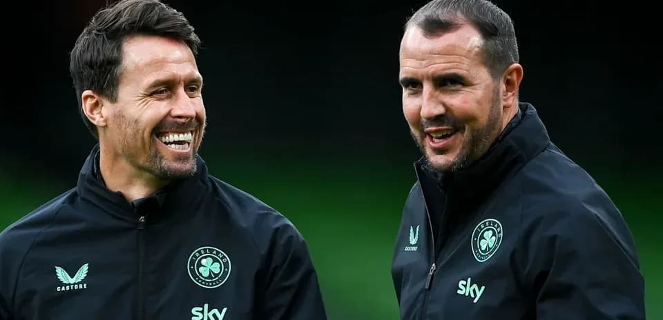 Two coaches smiling during training session