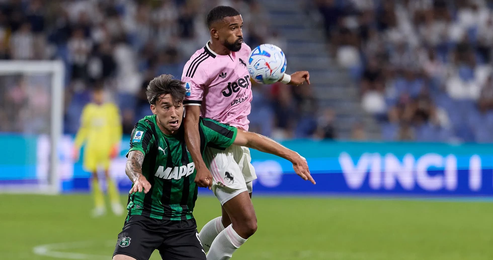 Player from Juventus challenging Sassuolo player for the ball