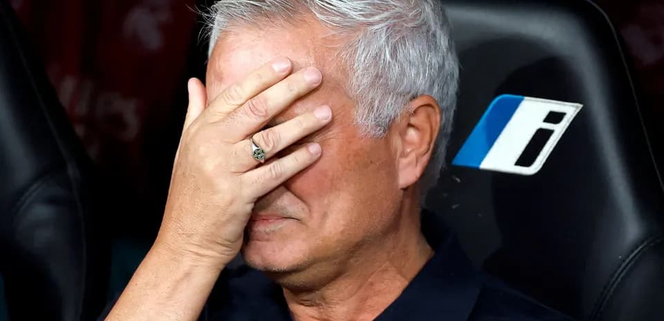 Coach with hand on face during match