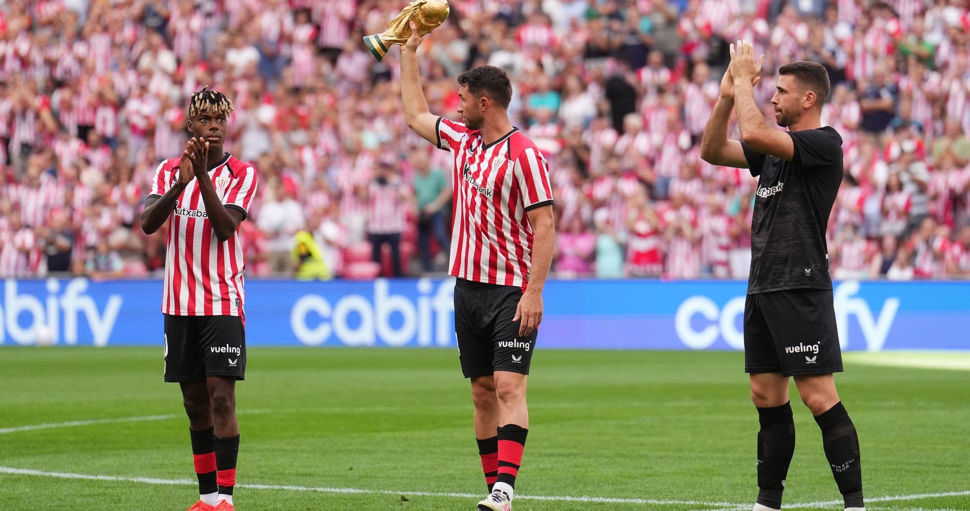 Players celebrating with trophy during match event