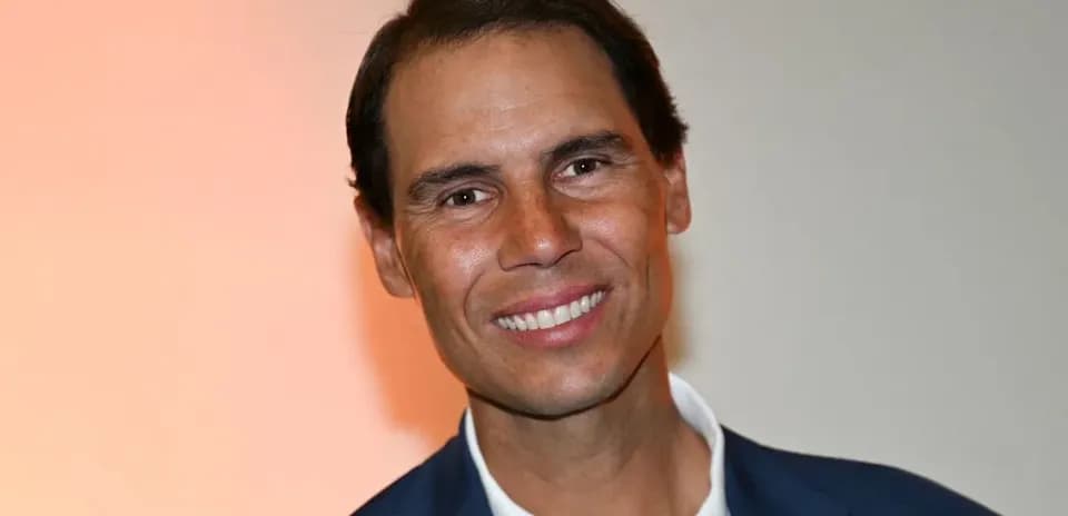 Smiling man in a suit with a light background