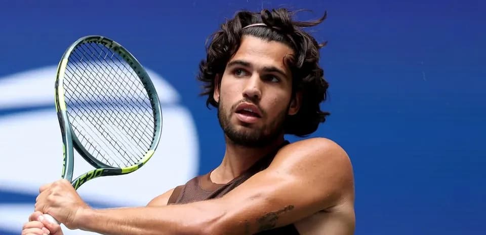 Tennis player preparing to hit a serve
