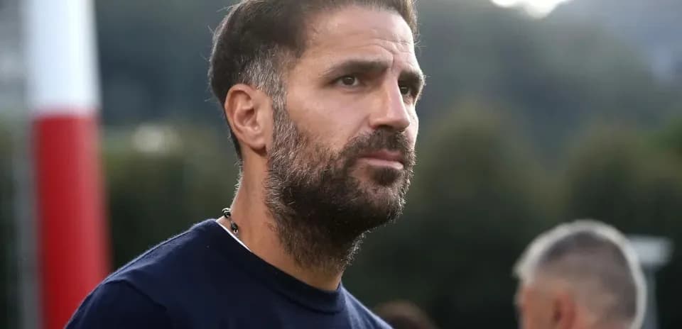 Man with beard observing training session in background