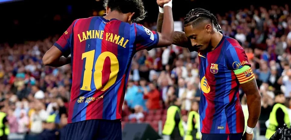 Two Barcelona players celebrating on the field