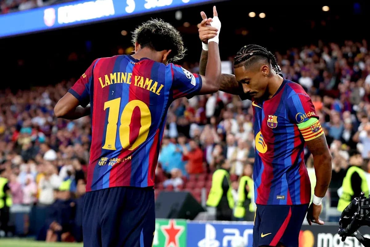 Two Barcelona players celebrating on the field