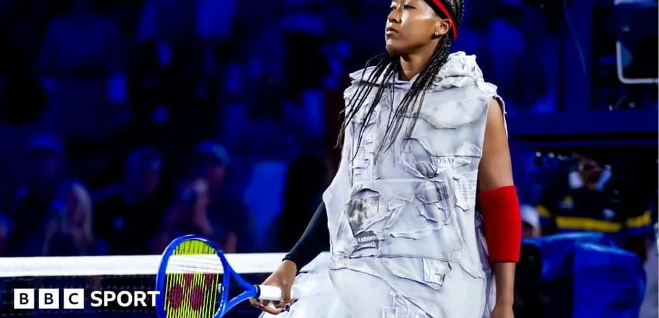 Naomi Osaka walking onto court with a racket