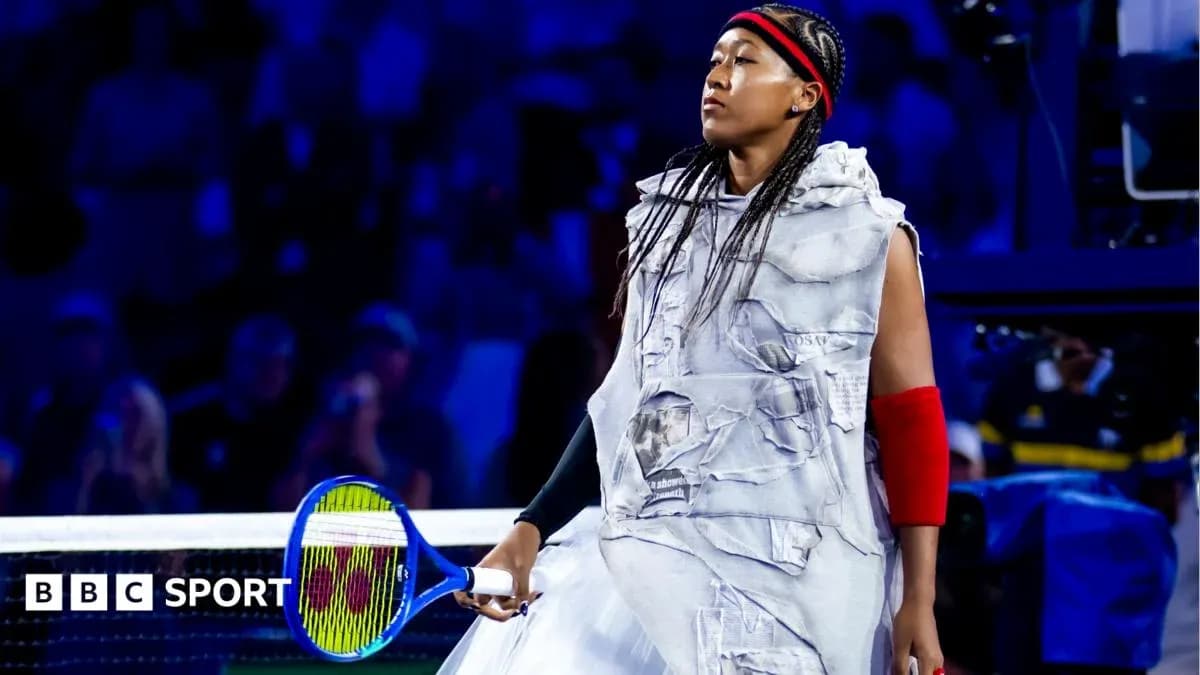 Naomi Osaka walking onto court with a racket