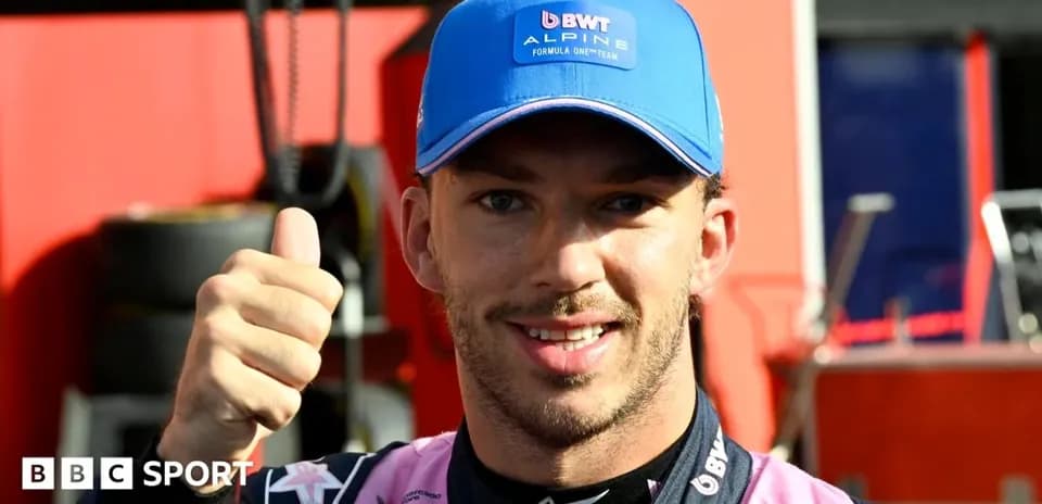 Driver giving thumbs up in team uniform