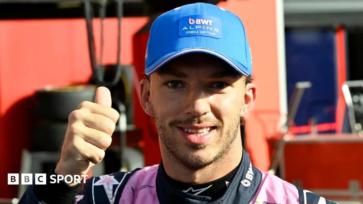 Driver giving thumbs up in team uniform