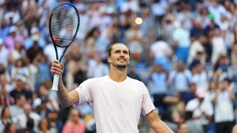 Player celebrating with racquet raised in crowd