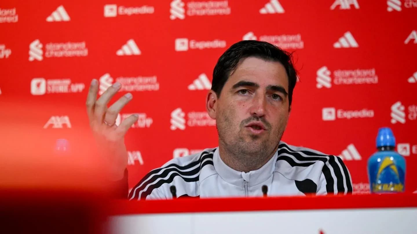 Manager speaking at press conference with sponsors' backdrop