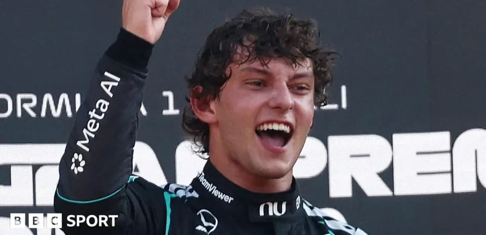 Racing driver celebrating victory with raised fist