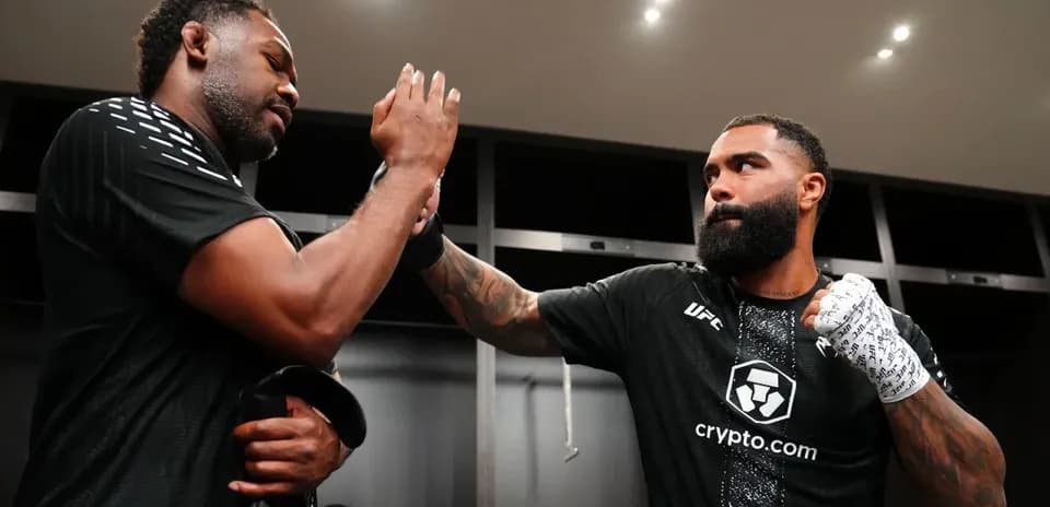 Two fighters exchanging a fist bump in locker room