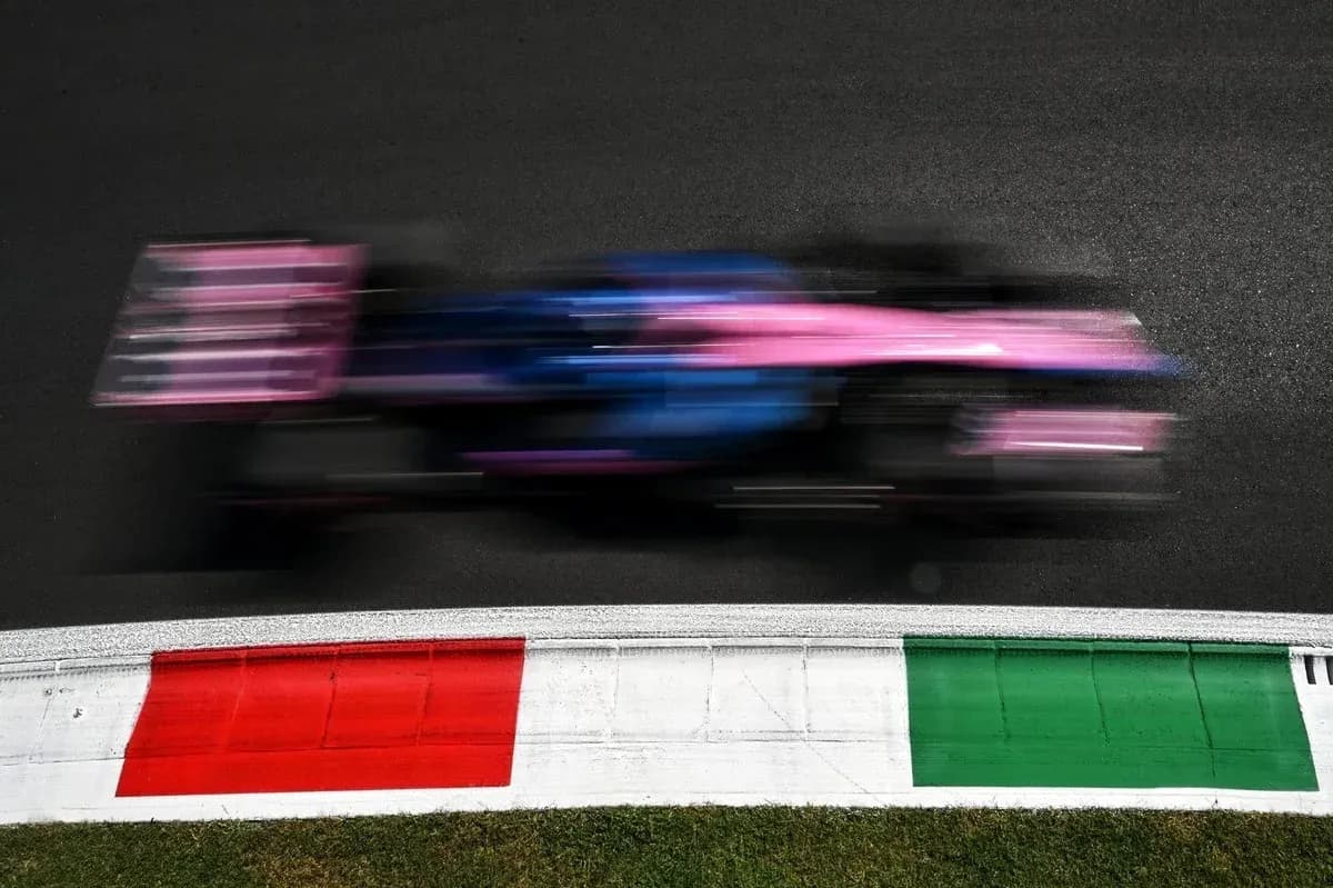 Formula 1 car racing past track curbing