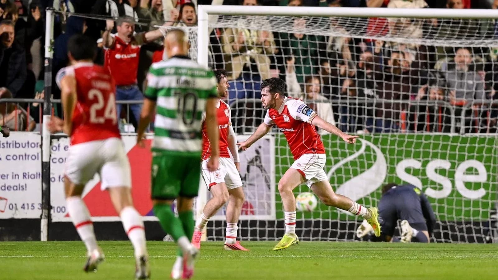 Player celebrating goal with teammates in match