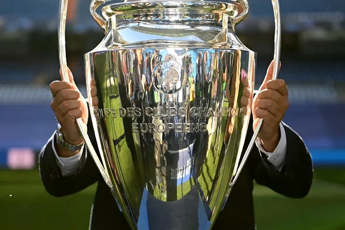 Champions League trophy held by an individual