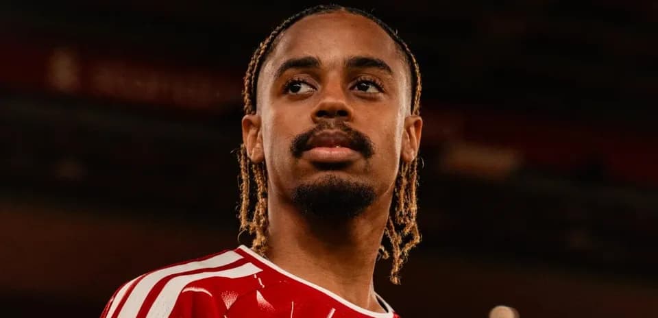 Player in red jersey posing for photo