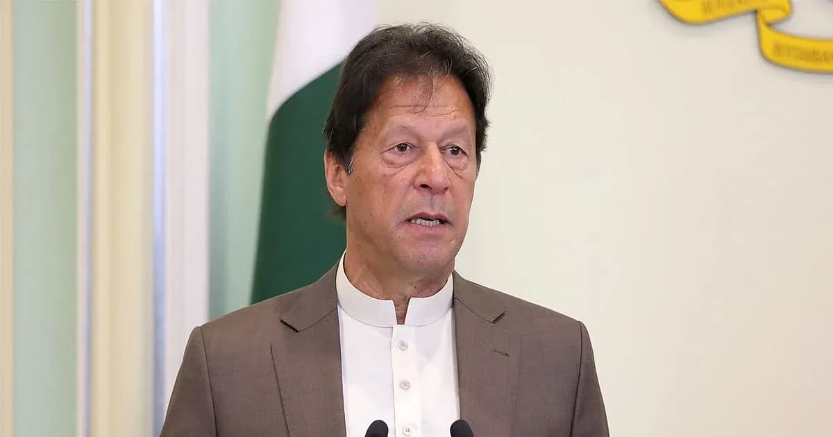 Man speaking at podium with Pakistani flag backdrop