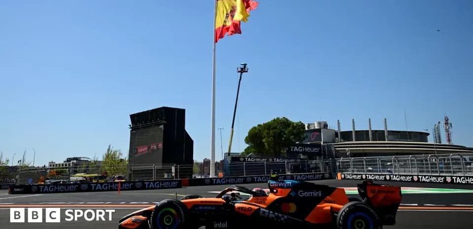 McLaren car racing with Spanish flag in background