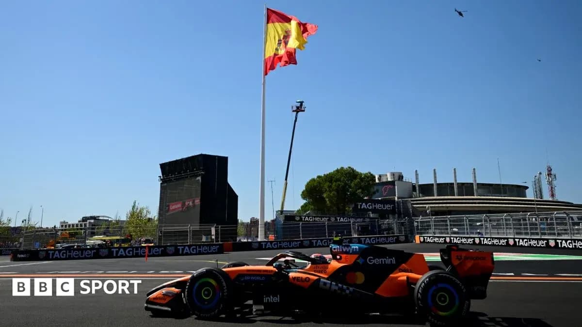 McLaren car racing with Spanish flag in background