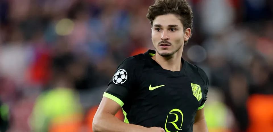 Player wearing Atletico Madrid kit on the pitch