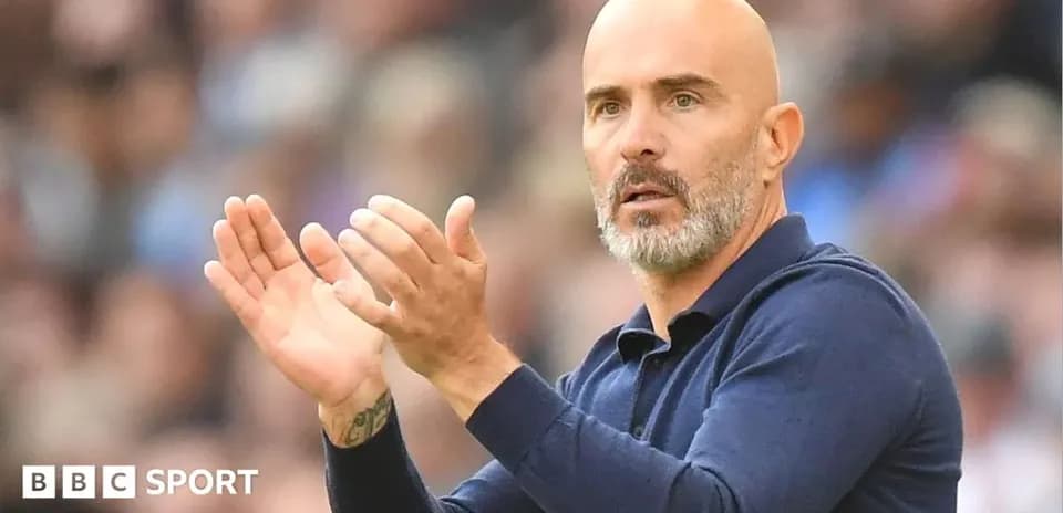 Coach clapping and directing players during match