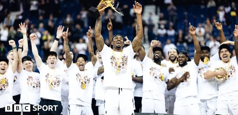 Player celebrating with trophy and teammates after victory
