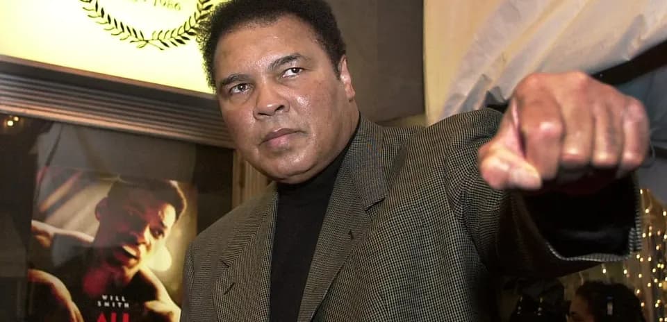 Muhammad Ali posing with a fist raised