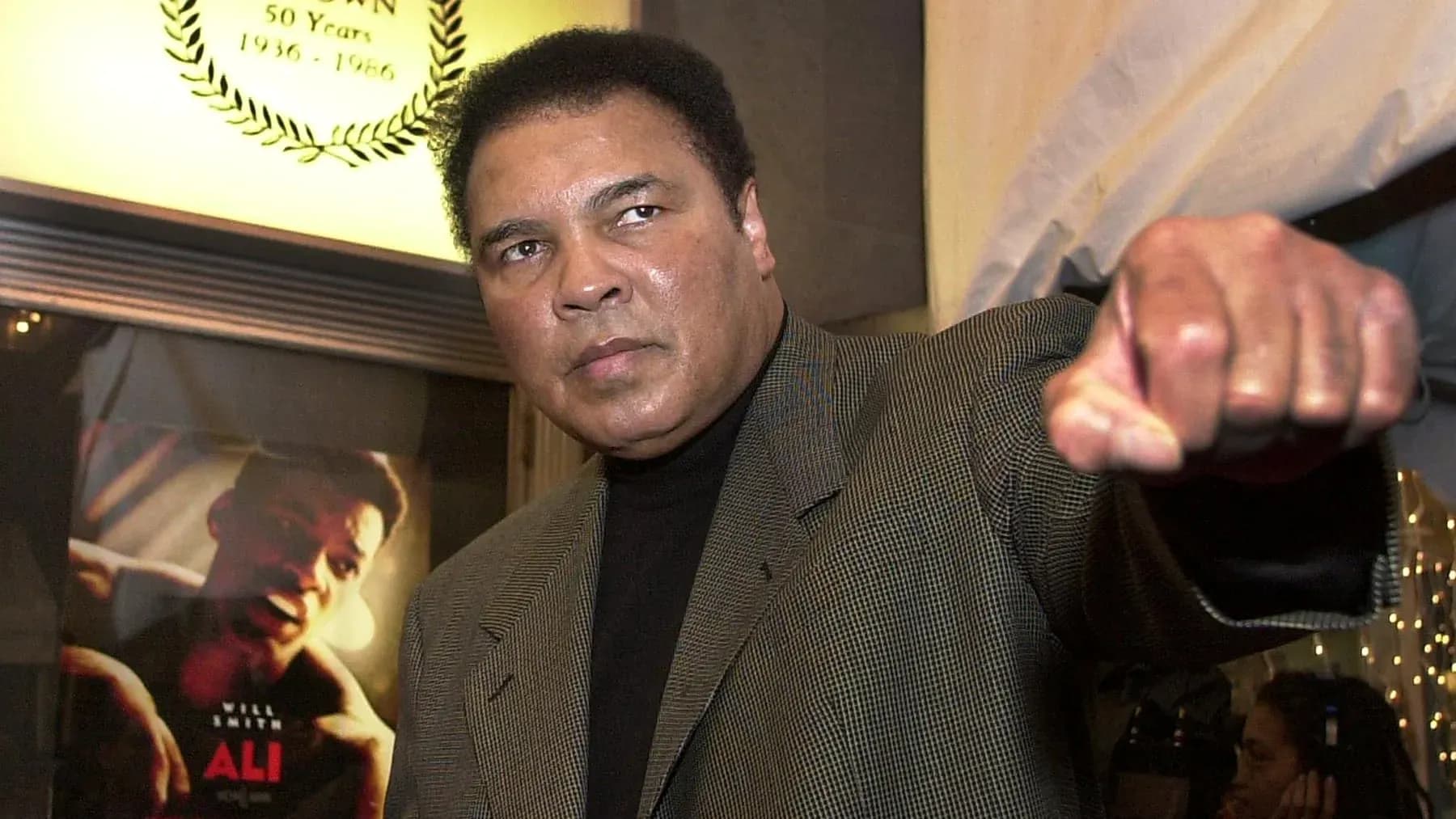 Muhammad Ali posing with a fist raised