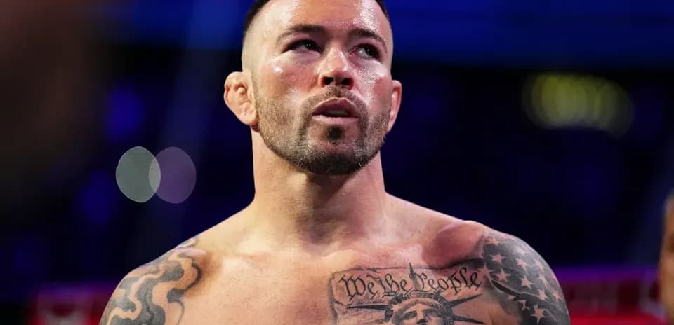 Boxer with tattoos preparing for fight in ring