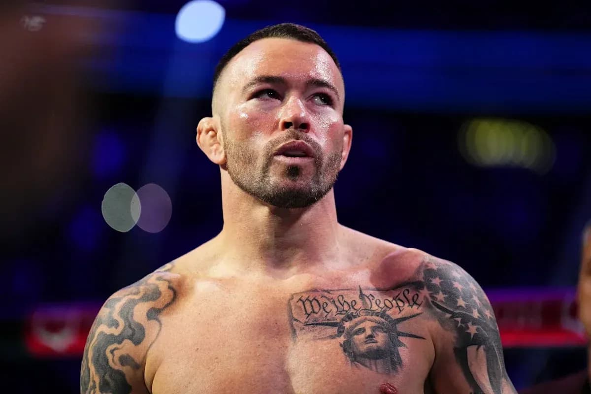 Boxer with tattoos preparing for fight in ring
