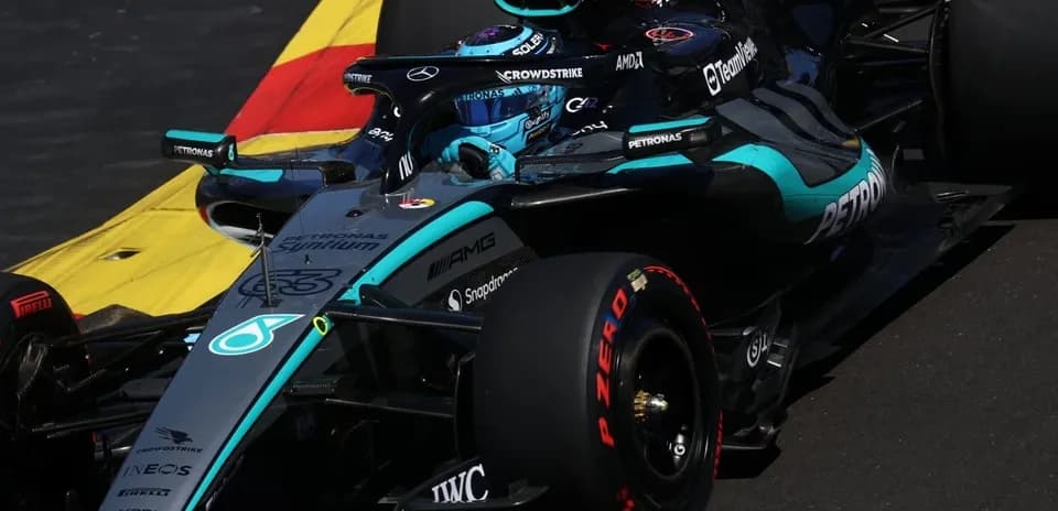 Mercedes F1 car navigating a racetrack corner